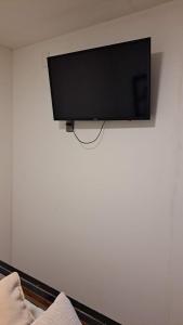 a flat screen tv hanging on a wall at Central Zenteno en Punta Arenas in Punta Arenas