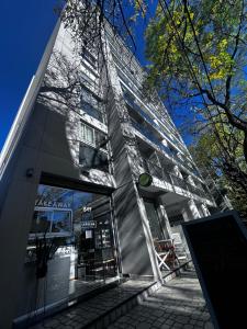 a tall building with a sign in front of it at Vista Haus in General Sarmiento