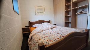 a bedroom with a bed with a comforter on it at Le Vieux Sart 1 in Stavelot