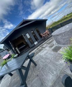 a house with a bench on a patio at CASSA Sophia in Ballygowan