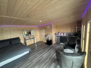 a room with a bed and a couch and a kitchen at CASSA Sophia in Ballygowan