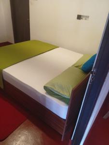 a small bed in a room with at Ella Top Sky in Bandarawela +2 photos
