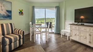 a living room with a table and a couch and a television at 2405 Ocean Pointe Suites in Tavernier