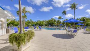 a pool with chairs and umbrellas at a resort at 2306 Ocean Pointe Suites in Tavernier