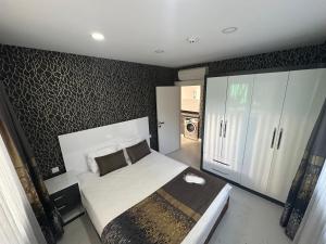 a bedroom with a large bed and a closet at Arya Apart Kundu Hotel in Lara
