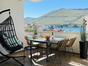 a table and chairs on a balcony with a view at Sea View Apartments in Grebaštica