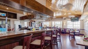 a restaurant with a bar with chairs and tables at 2306 Ocean Pointe Suites in Tavernier