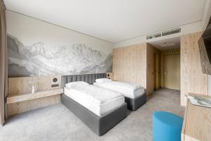 a bedroom with two beds and a painting on the wall at Snow Hotel Druskininkai in Druskininkai +43 photos