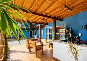a kitchen with a bar with a wooden ceiling at Beija Flor Pousada in Ubatuba