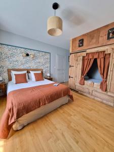 a bedroom with a large bed and a fireplace at DATCHA ANASTASIA in Besse-et-Saint-Anastaise