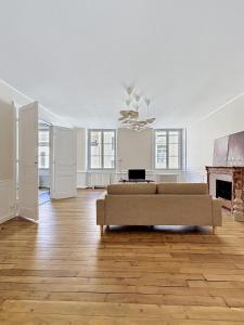 a living room with a couch and a fireplace at Maison Léon in Dole