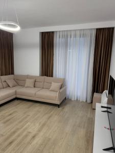 a living room with a couch and a table at Lunea Apartment Palm Residence in Vlorë