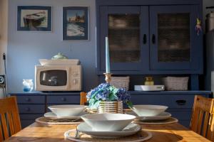 a dining room table with bowls and a candle on it at Apartman Jedro in Vukovar
