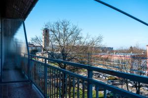 a balcony with a view of a factory at Apartman Jedro in Vukovar
