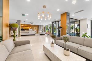 a living room with couches and a chandelier at Visula Hotel & Spa - New Opening 2026 in Medulin