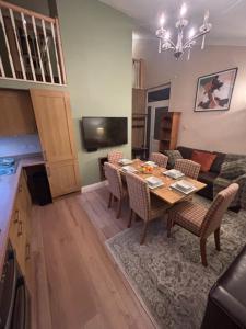a living room with a table and a couch at Hollybrake Haven Gatwick in Crawley