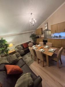a living room with a table and a couch at Hollybrake Haven Gatwick in Crawley