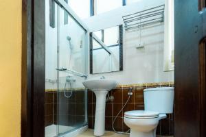 a bathroom with a toilet and a sink and a shower at Ban Lakkham River View in Luang Prabang +65 photos