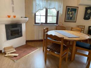 a dining room with a table and a fireplace at Sandbybäcksvägen 1 in Borrby