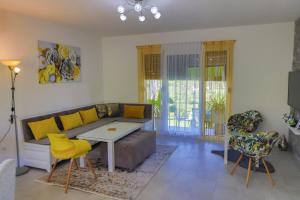 a living room with a couch and a table and chairs at Villa Bubinka in Bihać