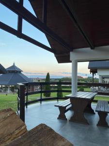 a patio with benches and a view of a field at Sterla - Masuria in Giżycko