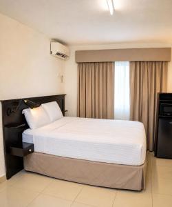 a bedroom with a large bed in a hotel room at The Jam Lodge in Freetown