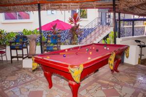 a red pool table in a room with a pool table at The Jam Lodge in Freetown