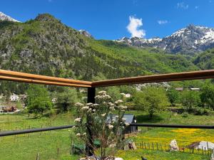 a view of mountains from the balcony of a house at Vila Shkalla in Theth +30 photos