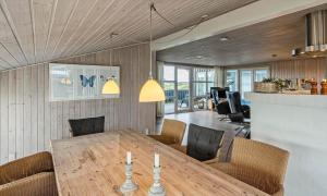 a dining room with a wooden table and chairs at VE265-Vejers-Strand-Nordvej-98-A in Vejers Strand