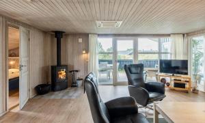 a living room with two chairs and a fireplace at VE265-Vejers-Strand-Nordvej-98-A in Vejers Strand