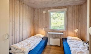 two beds in a room with a window at VE265-Vejers-Strand-Nordvej-98-A in Vejers Strand +26 photos