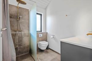 a bathroom with a shower and a toilet and a sink at HS018-Henne-Hennebysvej-8 in Henne Strand +22 photos