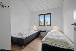 two twin beds in a room with a window at HS018-Henne-Hennebysvej-8 in Henne Strand