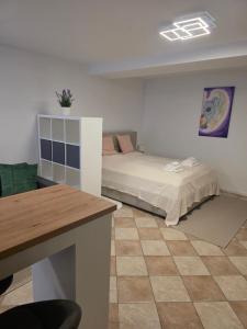 a room with two beds and a table in it at Cosy Studio CatHouse in Radovljica