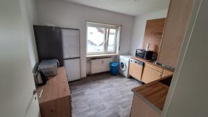 a small kitchen with a refrigerator and a window at Ferienwohnung Am Palmberg in Gerolsheim