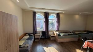 a room with two beds and two windows at DelMar in Klaipėda