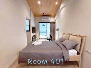 a bedroom with a bed in a room with a table at 崗崗好 Gangan House in San-fen-tzu