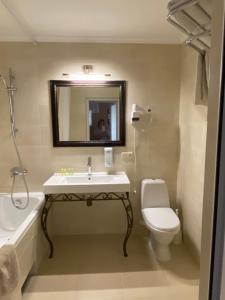 a bathroom with a sink and a toilet and a mirror at Житловий будинок in Bilhorod-Dnistrovskyi +18 photos