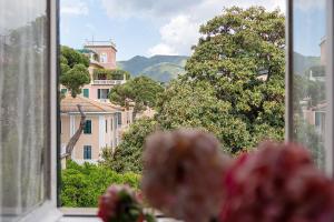 a view of a city from a window with flowers at Sentieri in Levanto