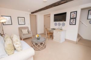 ein Wohnzimmer mit einem weißen Sofa und einem Tisch in der Unterkunft Carlton Towers Estate - Stapleton Rooms & Parkgate Cottages in Carlton
