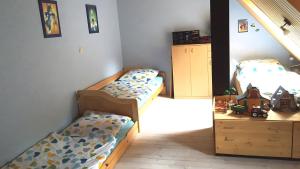 a bedroom with two beds and a wooden dresser at Ferienwohnung in Ivenack, DG in Ivenack +7 photos