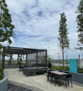 a person sitting at a picnic table in a park at Maru Maya Bay Guest House in Banting