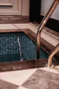 a bird drinking water from a sink in a bathroom at Summer Villa in Lahore