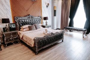 a bedroom with a large bed with a large ornate bed frame at Summer Villa in Lahore +217 photos