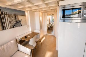 a living room with a couch and a microwave at Villa Bono Romantic Suite & Private Jacuzzi in Saint-Laurent-du-Var