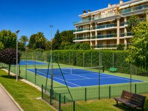 a tennis court in front of a hotel at Villa Bono Romantic Suite & Private Jacuzzi in Saint-Laurent-du-Var