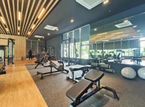 a gym with several treadms and cardio machines at Maru Maya Bay Guest House in Banting