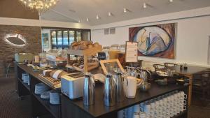 a kitchen with a counter filled with lots of food at Hotel Arctic - 4 Star Superior in Ilulissat