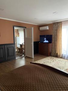 a bedroom with a bed and a sliding door at Житловий будинок in Bilhorod-Dnistrovskyi