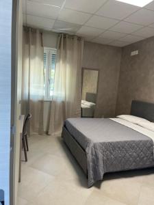 a bedroom with a bed and a mirror at Moon Valley Holiday Home in Lauria Inferiore
